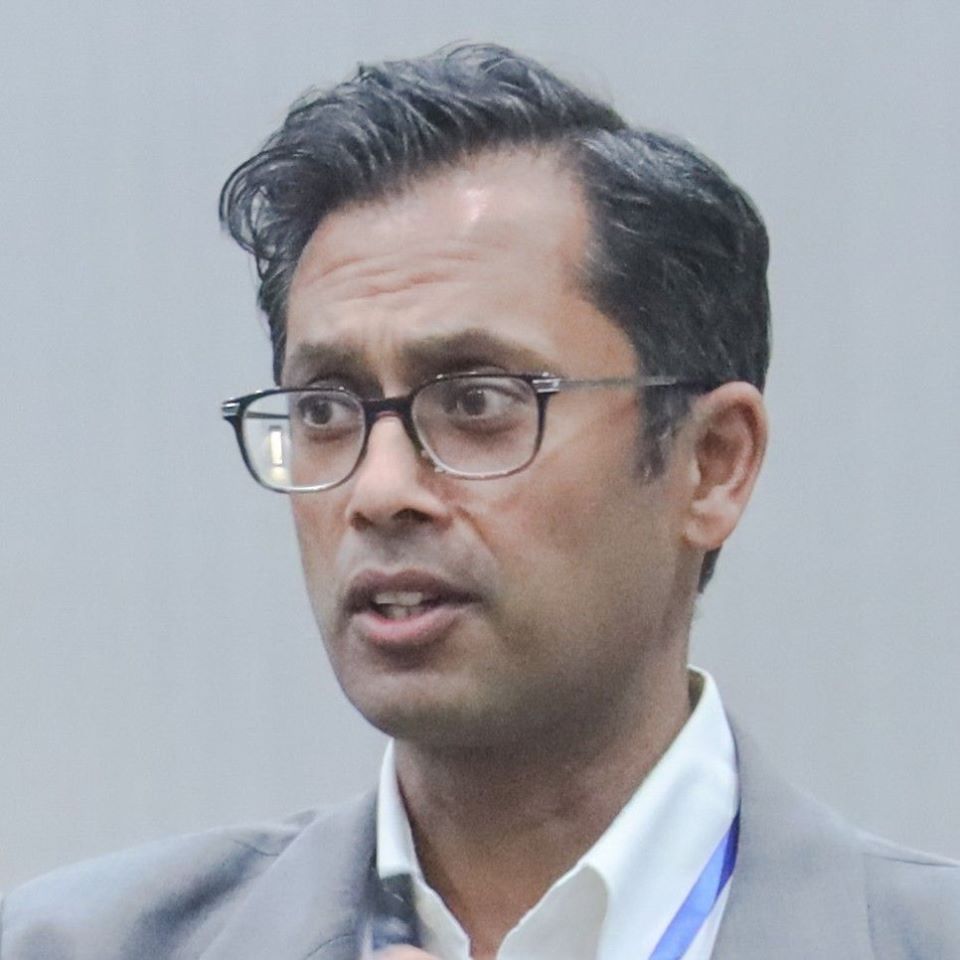 picture of Apoorv Dwivedi on stage at a speaking event.